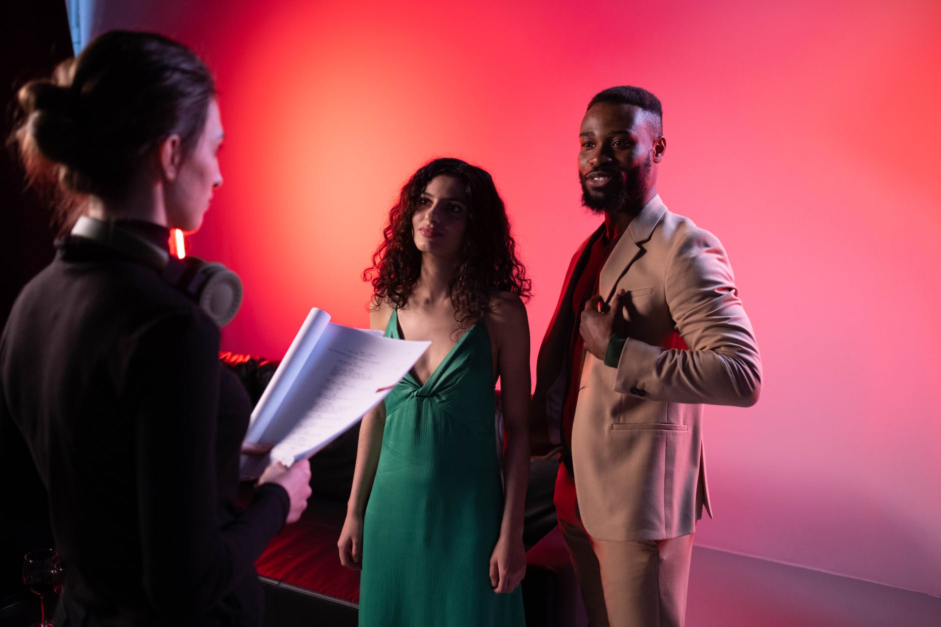 a woman in black long sleeves talking to the man and woman looking at her